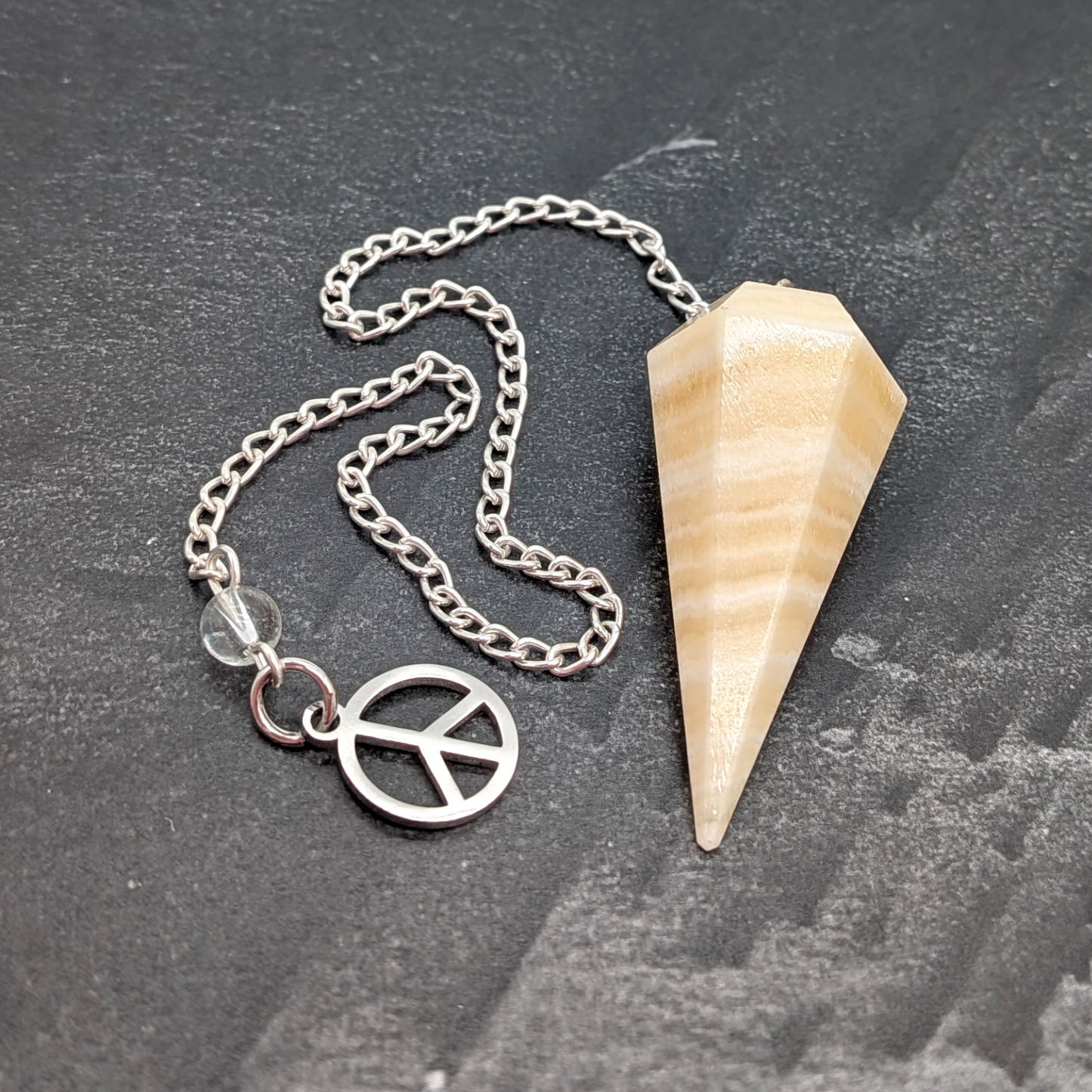Orange Calcite Pendulum with Peace Sign Charm